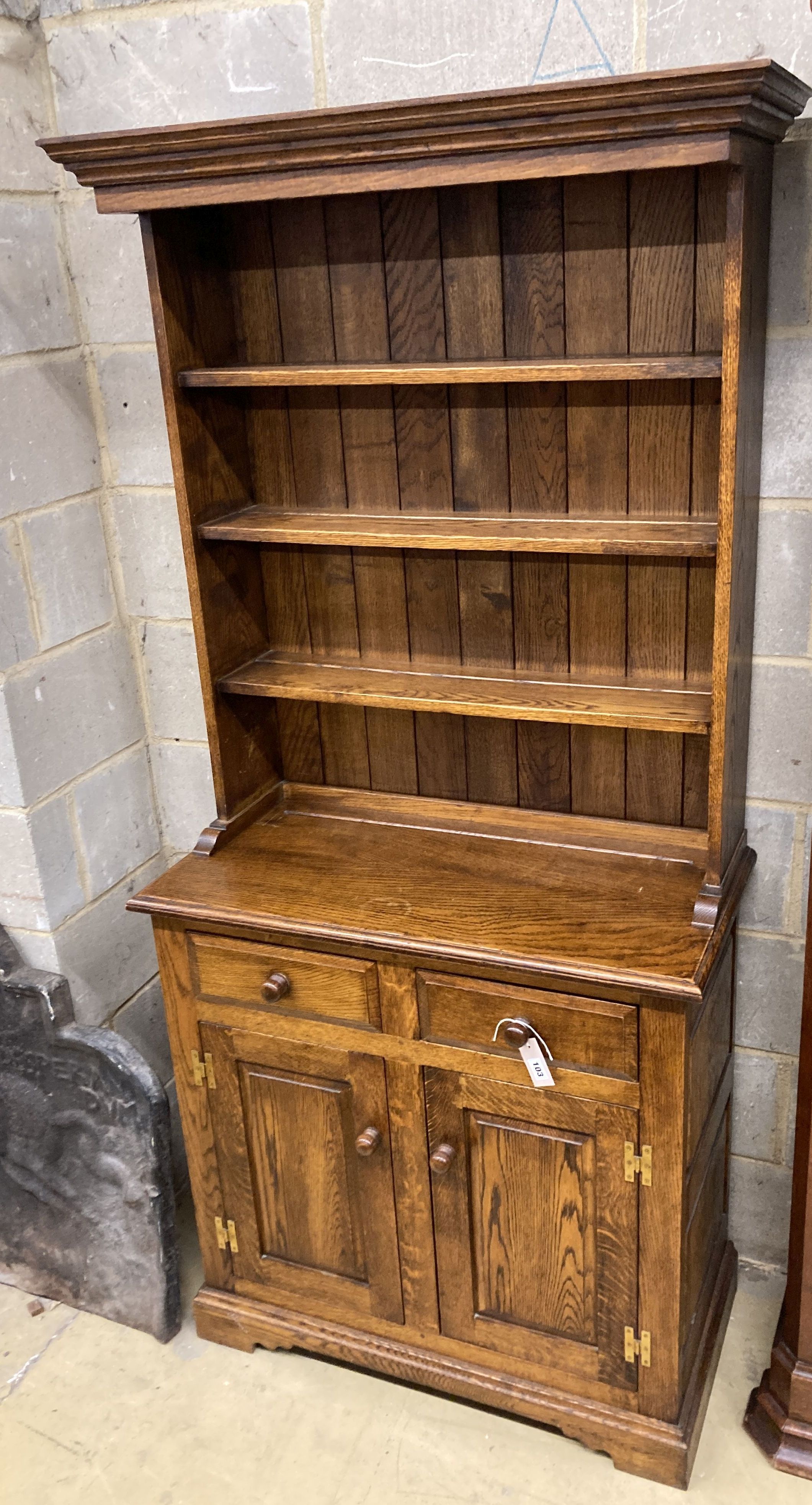 A small 18th century style narrow oak dresser, length 86cm, depth 43cm, height 187cm